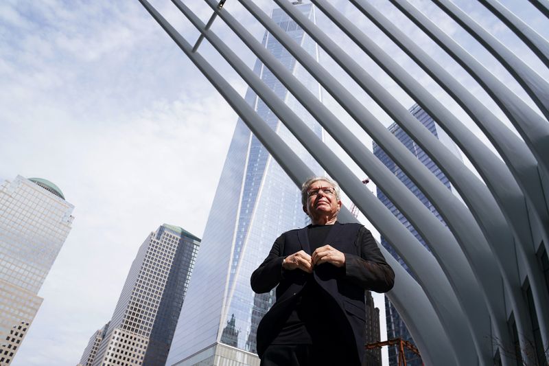Architect Daniel Libeskind does up his jacket as he poses