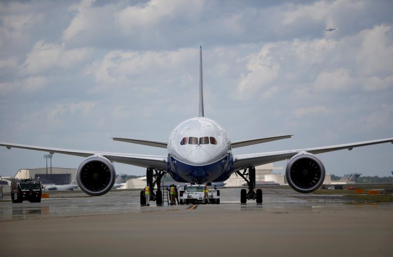 FILE PHOTO: Workers check over the new Boeing 787-10 Dreamliner
