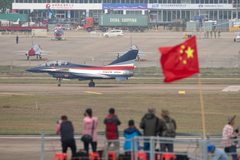 People take photos of aircraft of Chinese People’s Liberation Army