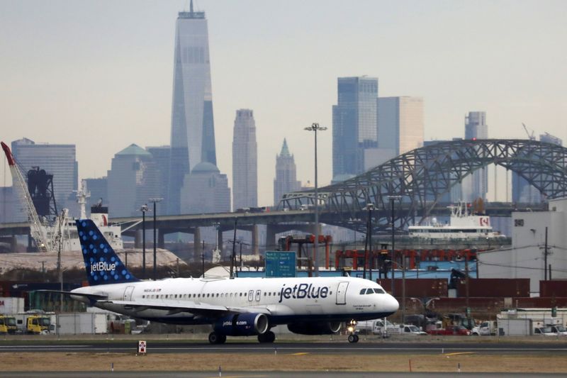 A JetBlue passenger jet lands with New York City as