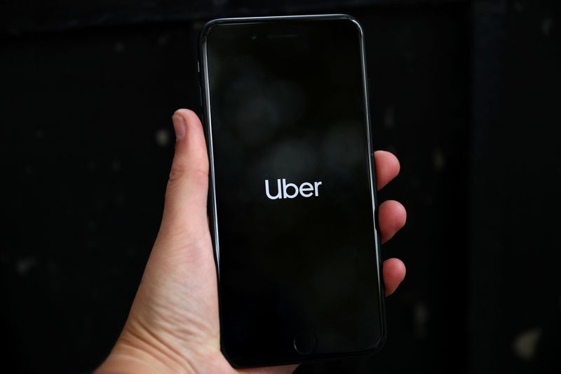 FILE PHOTO: Uber’s logo is displayed on a mobile phone