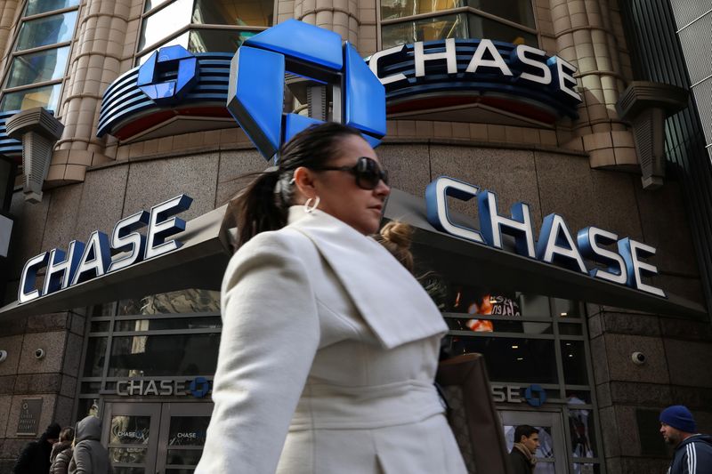 A woman passes by a Chase bank in Times Square
