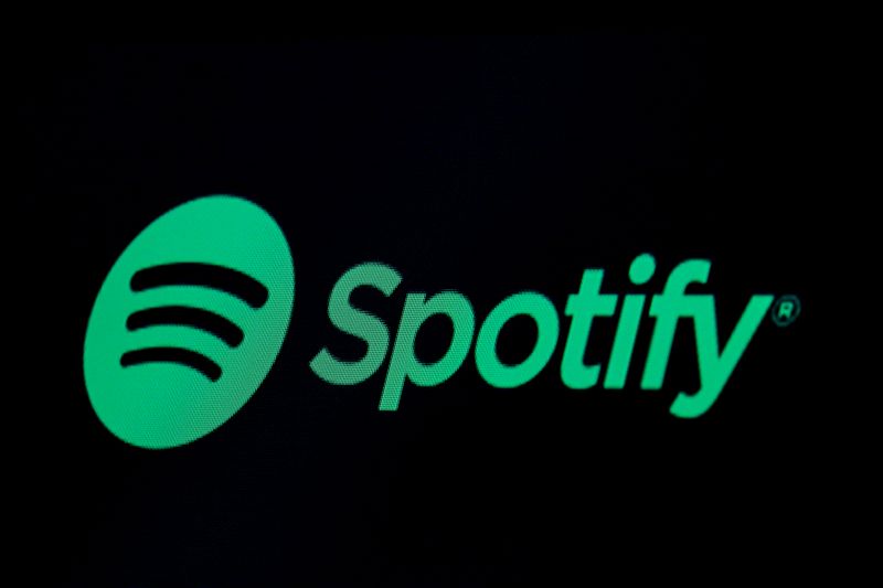 The Spotify logo is displayed on a screen on the