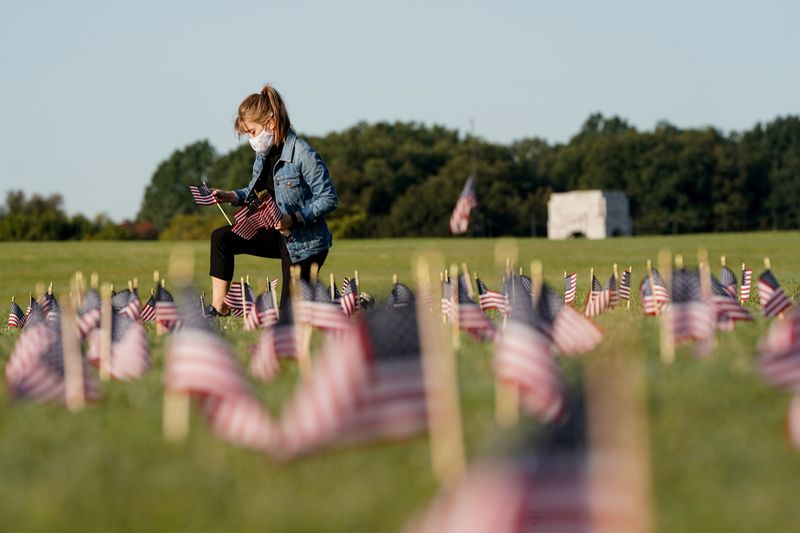 FILE PHOTO: American flags representing 200,000 lives lost due to