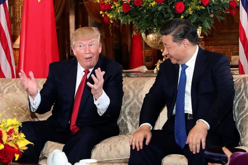 FILE PHOTO: U.S. President Donald Trump interacts with Chinese President