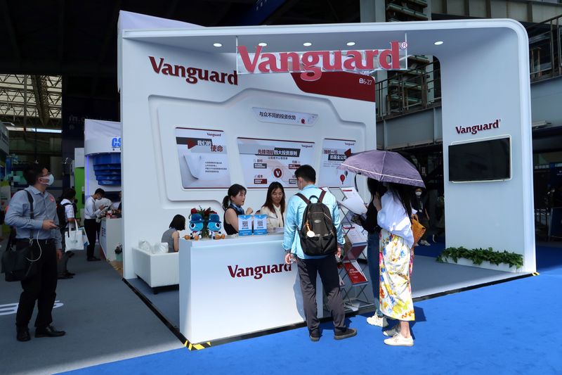 People are seen at a booth of Vanguard Group at