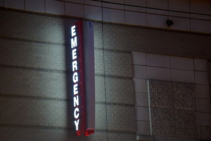 An emergency sign illuminates outside of George Washington University Hospital