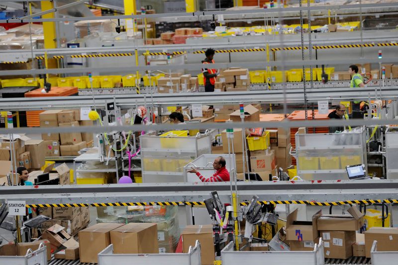 FILE PHOTO: FILE PHOTO: Amazon workers perform their jobs inside