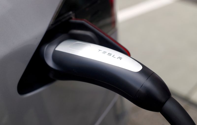 FILE PHOTO: A Tesla car is charged at a super-fast