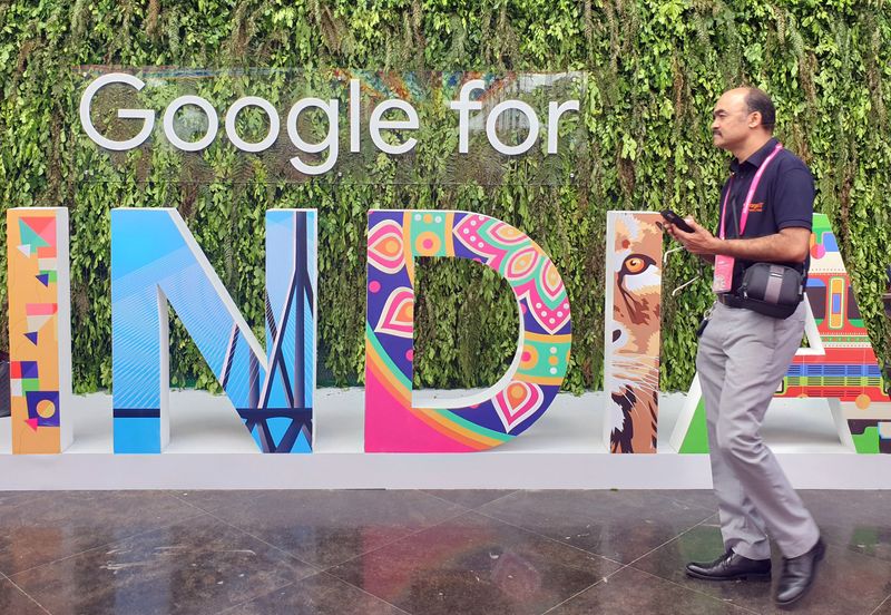 FILE PHOTO: A man walks past the sign of “Google