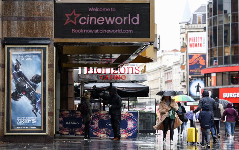 People walk past a Cineworld in Leicester’s Square in London