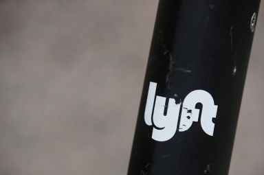 The Lyft  logo is seen on a parked Lyft