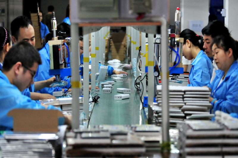 FILE PHOTO: Employees work on a production line manufacturing lithium