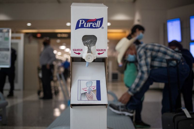 FILE PHOTO: Hand sanitizing station is seen after passengers pass