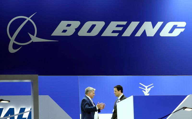 Visitors talk on the Boeing stand during the EBACE at