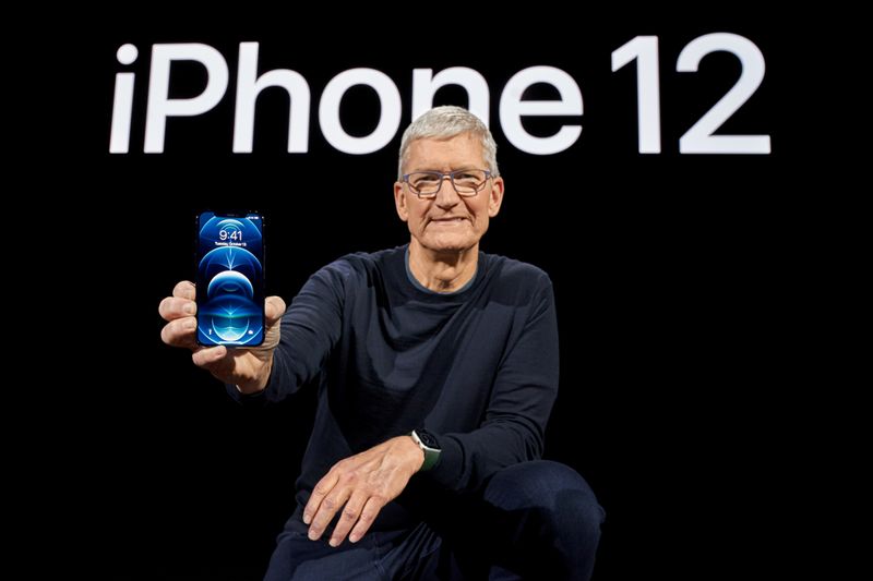 Apple CEO Tim Cook poses with the all-new iPhone 12