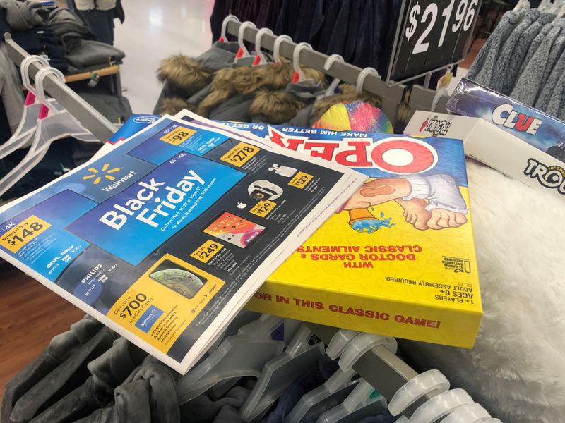 FILE PHOTO: Black Friday ads lay on top of clothes