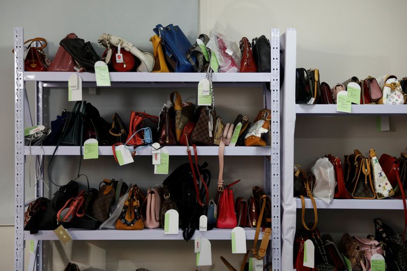 Handbags are seen on shelves during a livestreaming session for