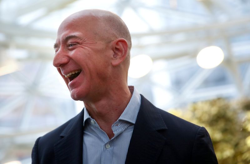FILE PHOTO: Amazon founder and CEO Jeff Bezos laughs as