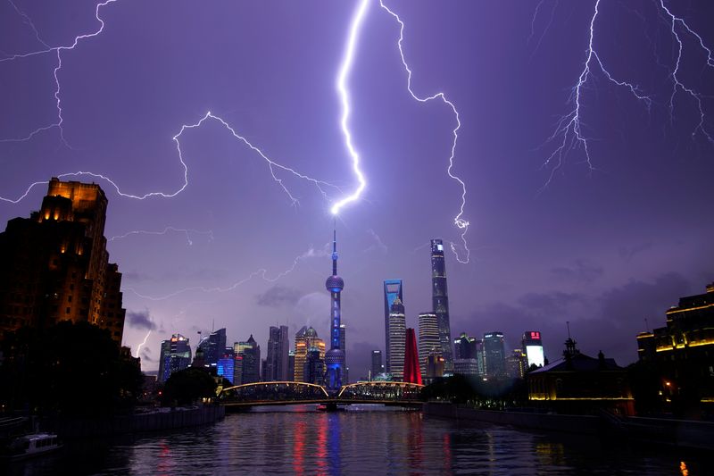 Lightning strikes are seen above the skyline of Shanghai’s financial
