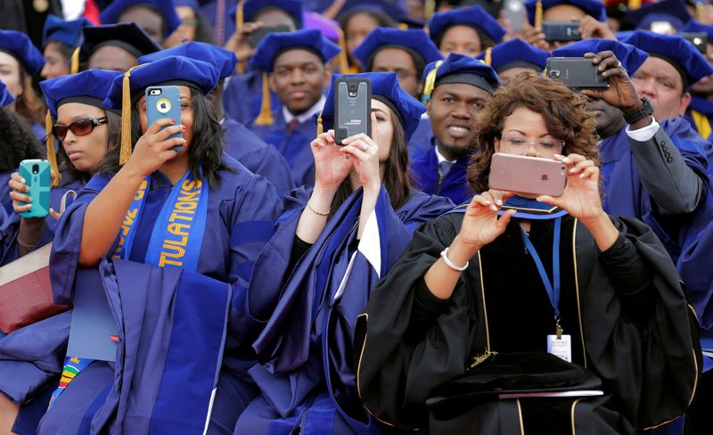 FILE PHOTO: Students photograph U.S. President Barack Obama with their