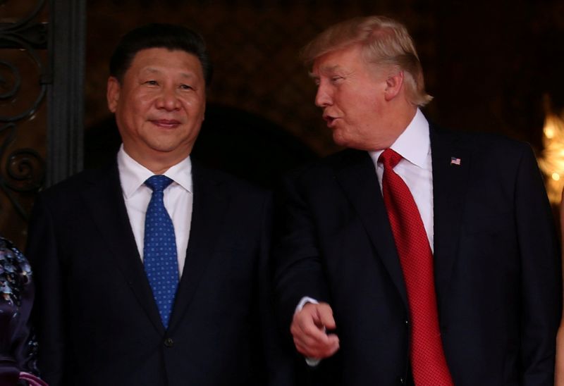 FILE PHOTO: U.S. President Trump talks with Chinese President Xi