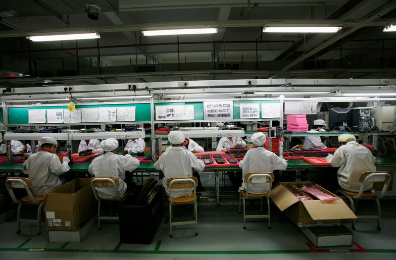 FILE PHOTO: Workers are seen inside a Foxconn factory in