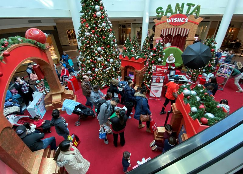 FILE PHOTO: Families wait in line to meet Santa Claus