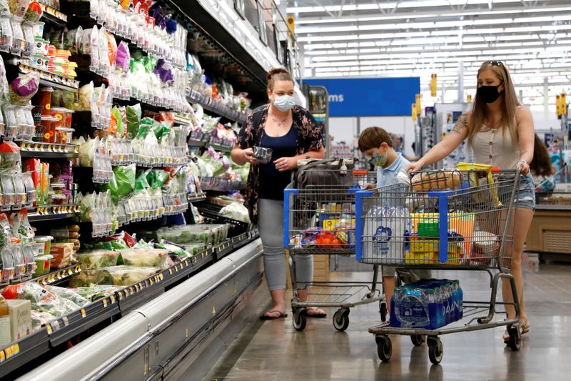 Shoppers are seen wearing masks while shopping at a Walmart