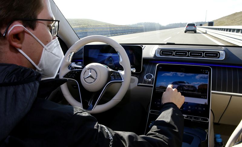An employee demonstrates steering by autonomous driving system in a