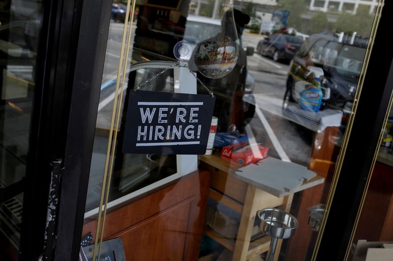FILE PHOTO: A “We’re Hiring” sign advertising jobs is seen