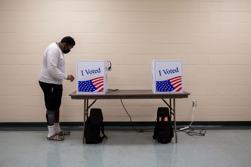 FILE PHOTO: People cast their ballot during early voting in
