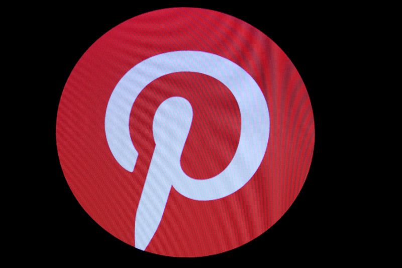 Screens display the company logo for Pinterest Inc. during the
