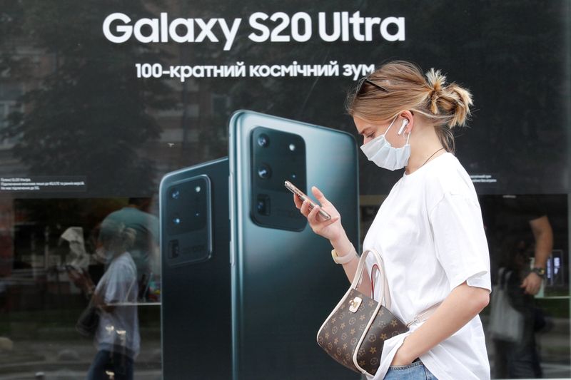FILE PHOTO: A woman walks past a Samsung brand store