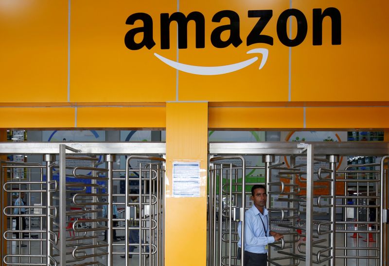 An employee of Amazon walks through a turnstile gate inside