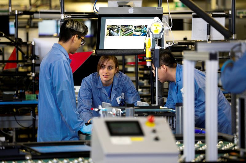 FILE PHOTO: Flextronics International Apple factory employees work on Apple