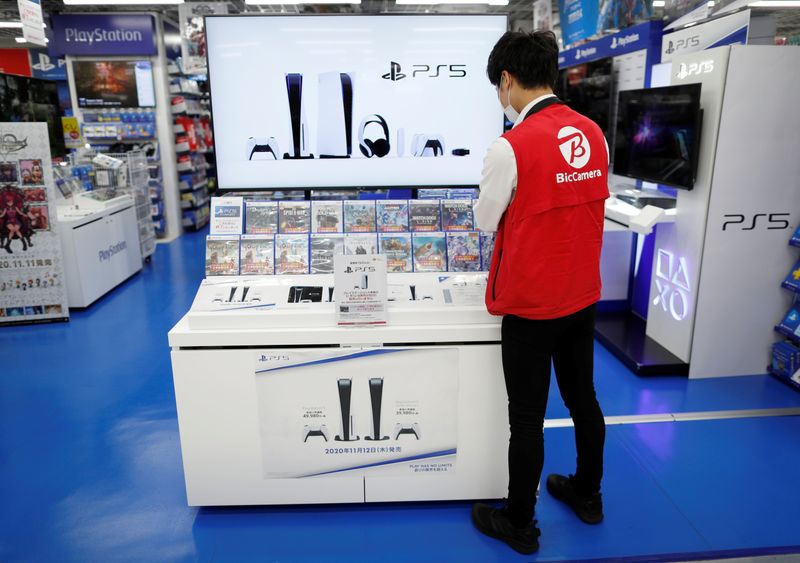 An employee works at the promotion display for the Sony