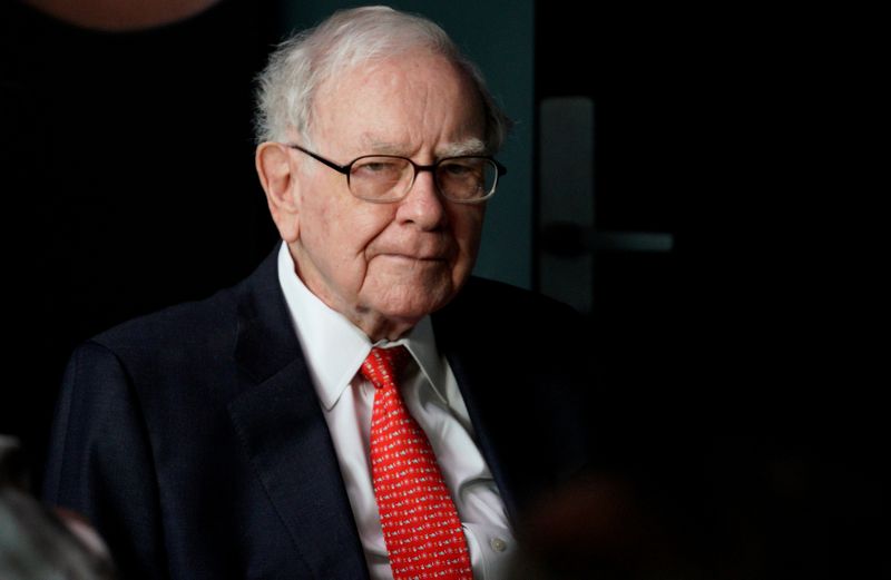 Warren Buffett, CEO of Berkshire Hathaway Inc, pauses while playing