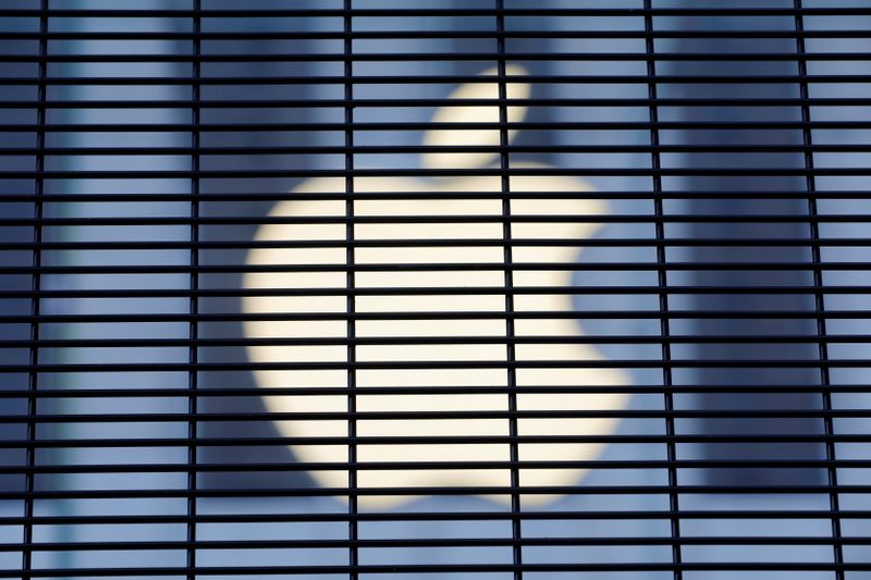 The Apple logo is seen through a security fence erected