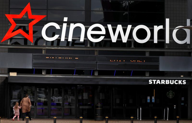 People enter a Cineworld cinema following the outbreak of the