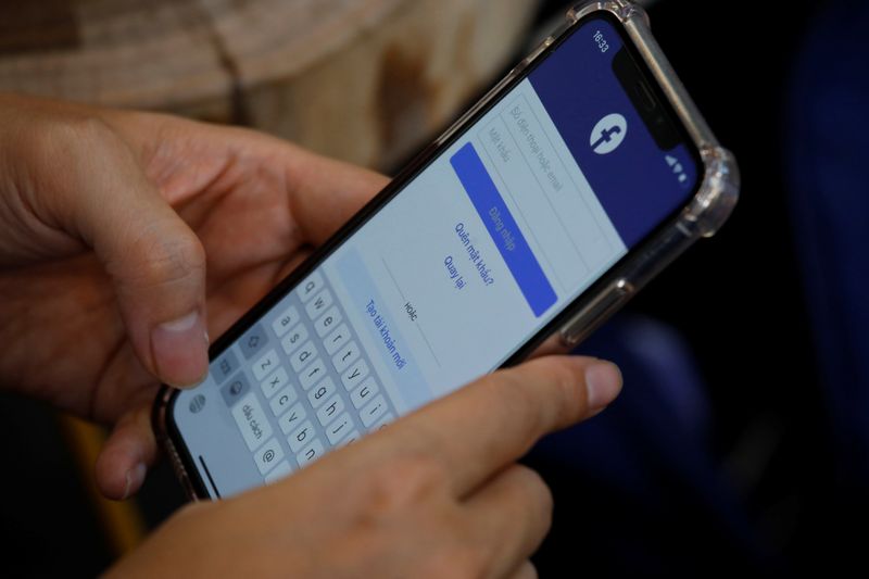 A Facebook user logs in on his mobile at a