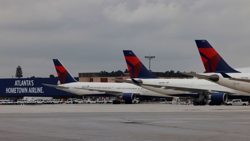 Delta Air Lines planes are parked at their gates in