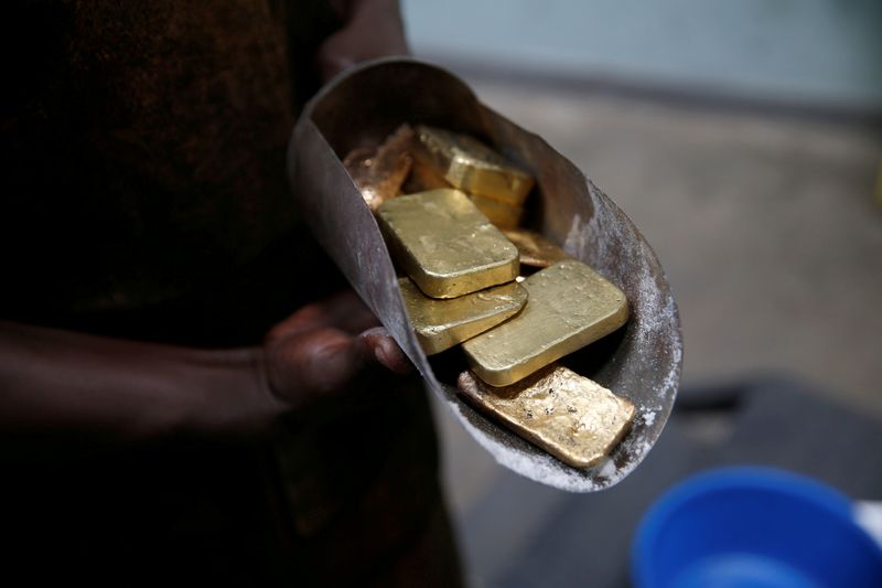 FILE PHOTO: An employee holds gold bars before the refining