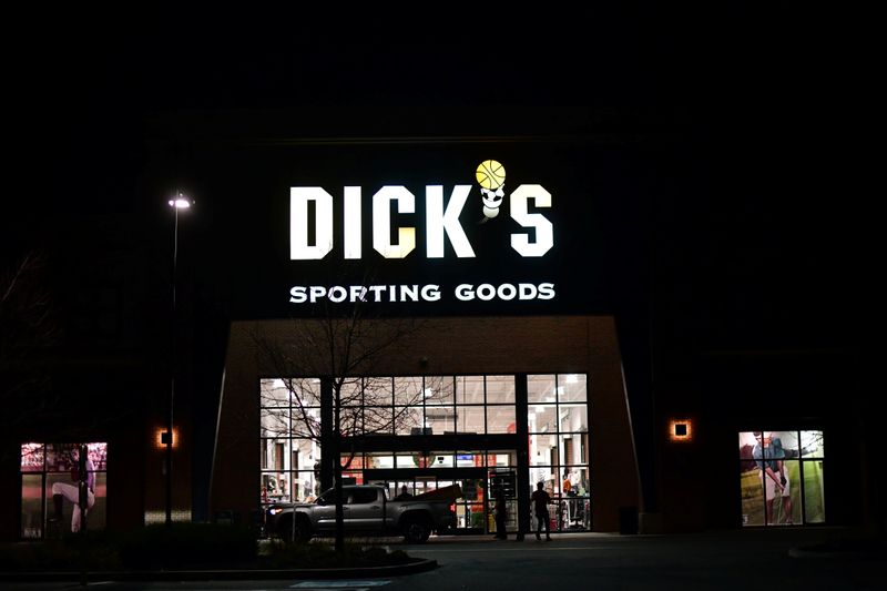 Shoppers load purchased merchandise into a truck outside a Dick’s