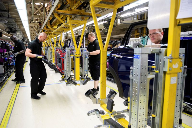 FILE PHOTO: Workers assemble cars at the plant for the