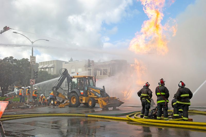 FILE PHOTO: Firefighters battle a fire following an explosion at