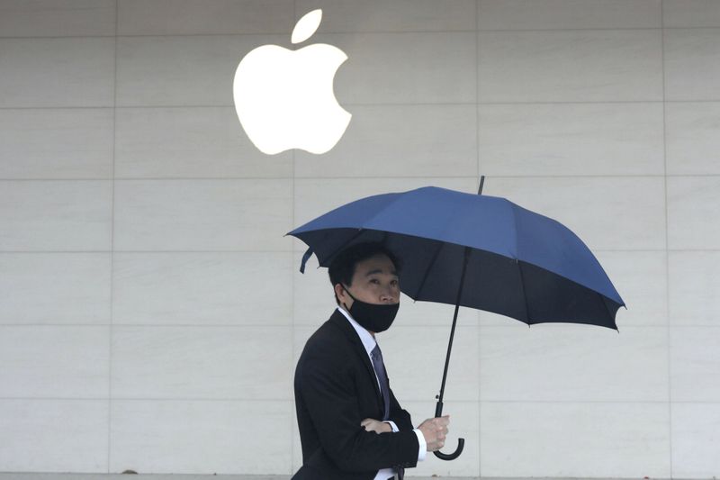 FILE PHOTO: A man walks past an Apple store in