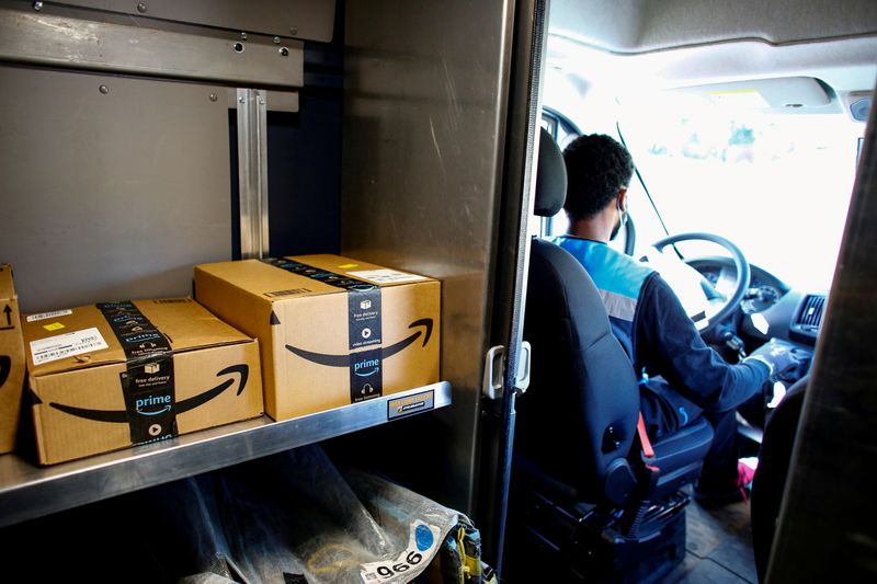 FILE PHOTO: An Amazon worker delivers packages