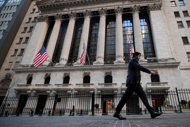 FILE PHOTO: A man walks outside the NYSE in New