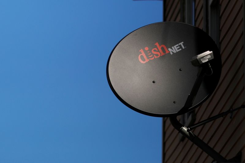 A Dish Network receiver hangs on a house in Somerville
